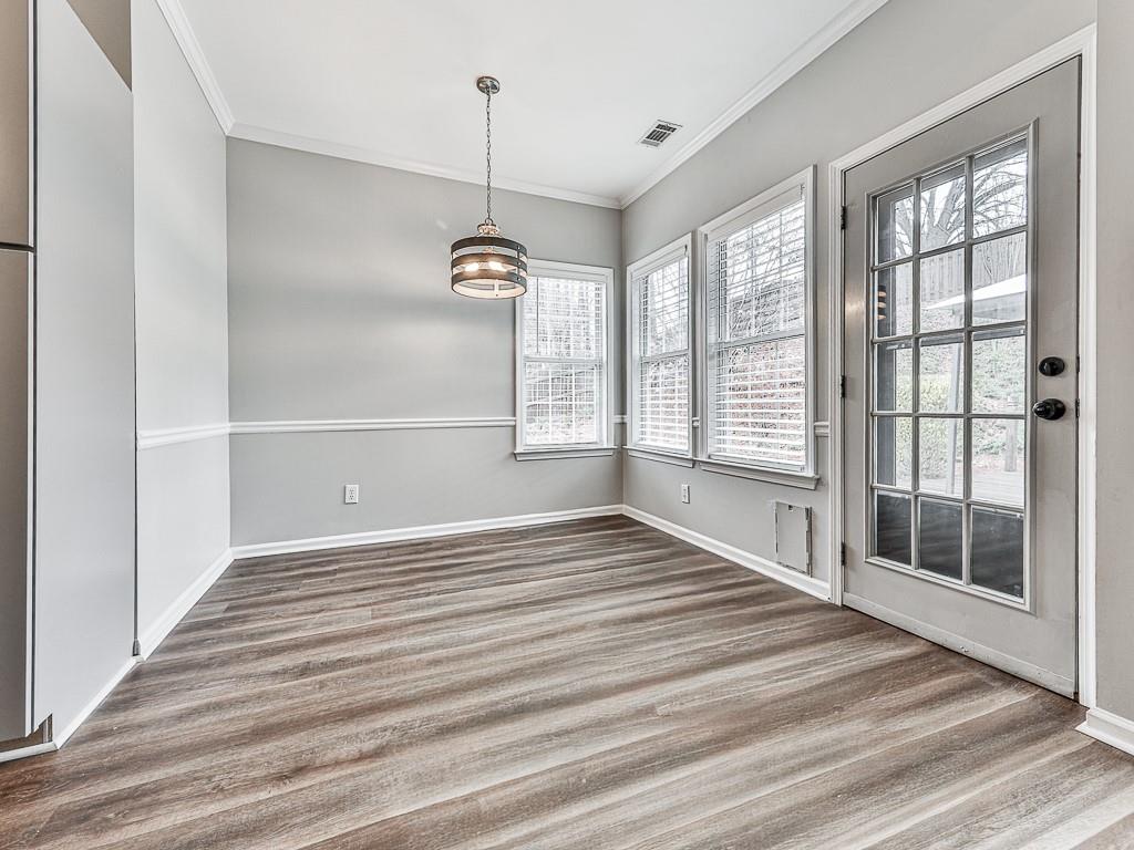 102 Springshade Court Canton, GA 30114 - Photo 16 of 78 a view of an empty room with a window and wooden floor