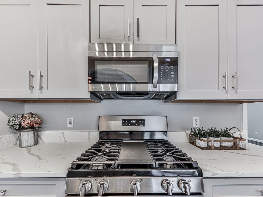 102 Springshade Court Canton, GA 30114 - Photo 18 of 78 a kitchen with white cabinets and appliances