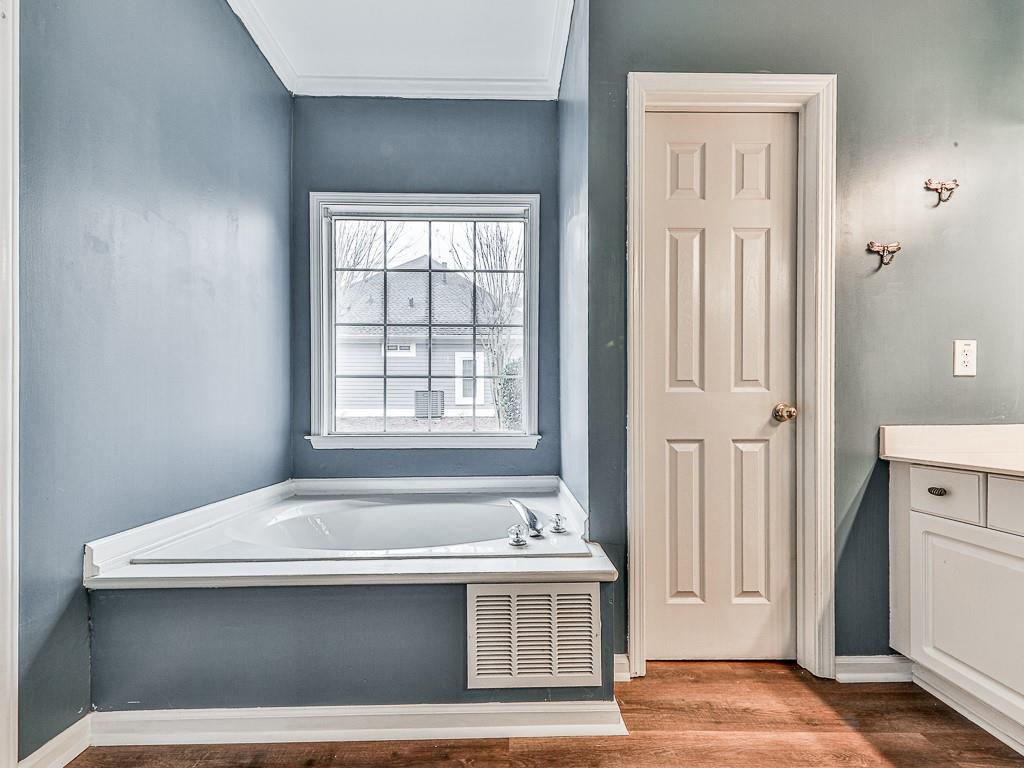 102 Springshade Court Canton, GA 30114 - Photo 28 of 78 a view of a bedroom with a bed and wooden floor