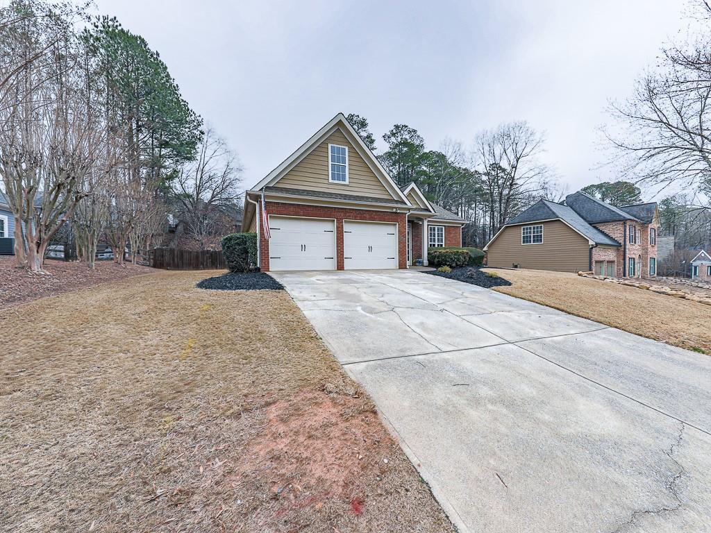 102 Springshade Court Canton, GA 30114 - Photo 32 of 78 a front view of a house with a yard and trees