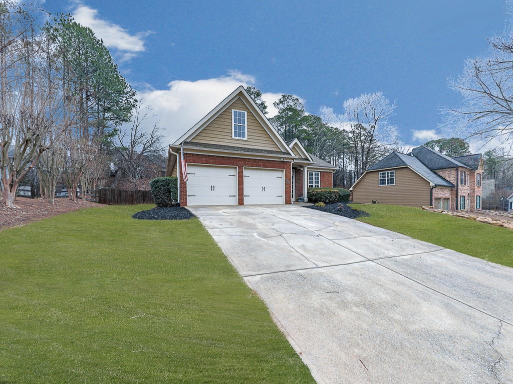 102 Springshade Court Canton, GA 30114 - Photo 33 of 78 a front view of a house with a yard and garage