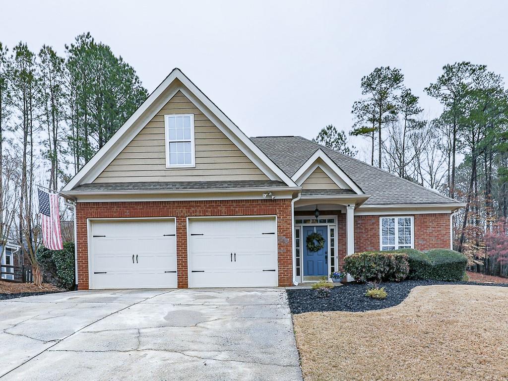 102 Springshade Court Canton, GA 30114 - Photo 39 of 78 a front view of a house with a yard and garage