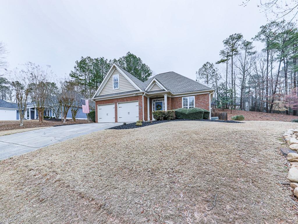 102 Springshade Court Canton, GA 30114 - Photo 40 of 78 a front view of a house with a dirt yard and a large tree