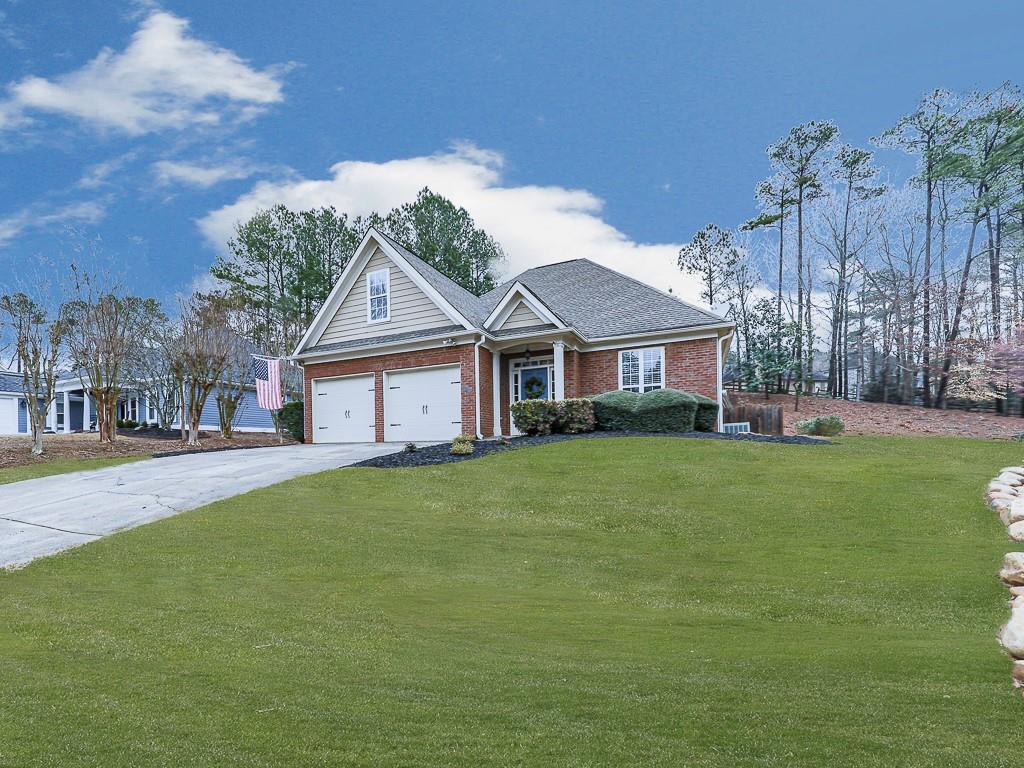 102 Springshade Court Canton, GA 30114 - Photo 41 of 78 a front view of a house with a garden and porch