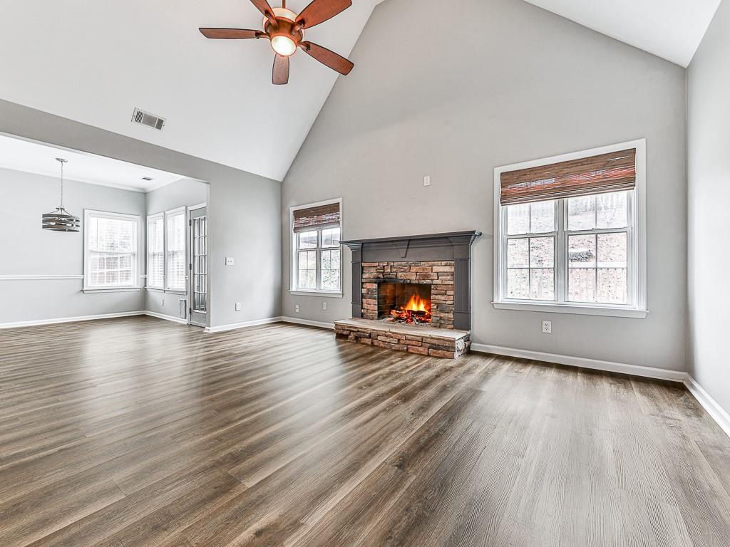 102 Springshade Court Canton, GA 30114 - Photo 10 of 78 an empty room with windows fireplace and wooden floor