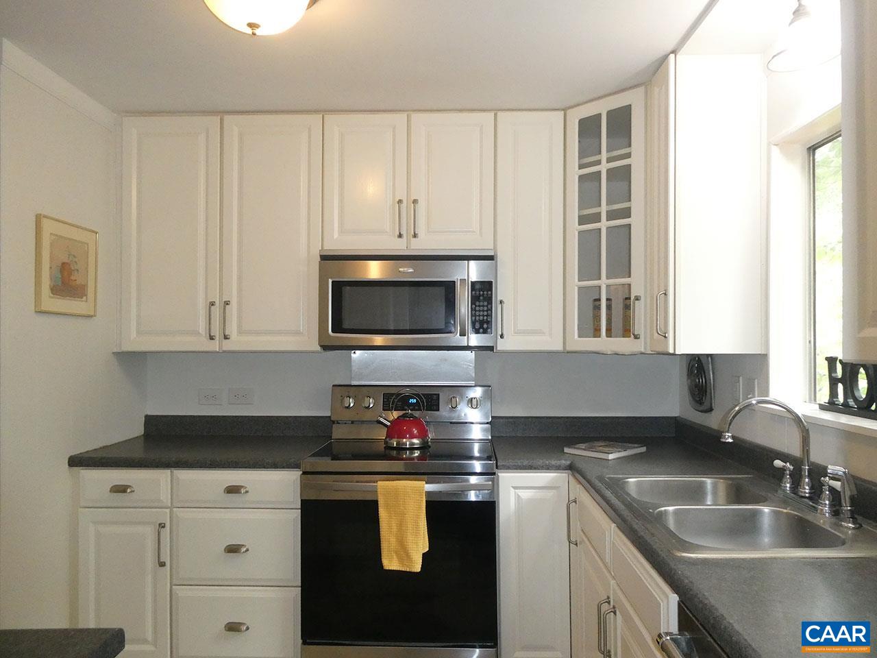 613 Shamrock Road Charlottesville, VA 22903 - Photo 12 of 42 a kitchen with granite countertop white cabinets and stainless steel appliances