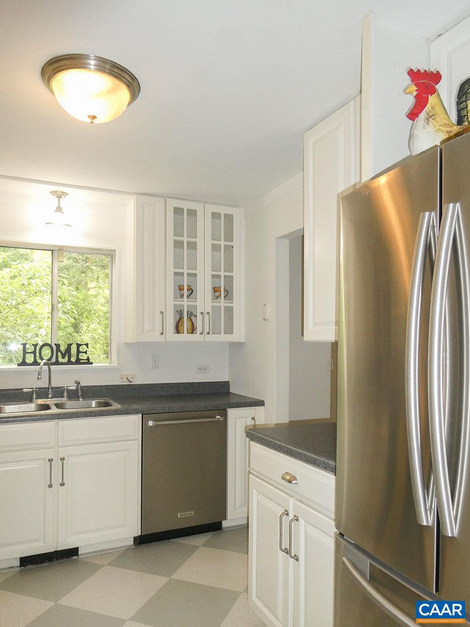 613 Shamrock Road Charlottesville, VA 22903 - Photo 13 of 42 a kitchen with white cabinets and a sink