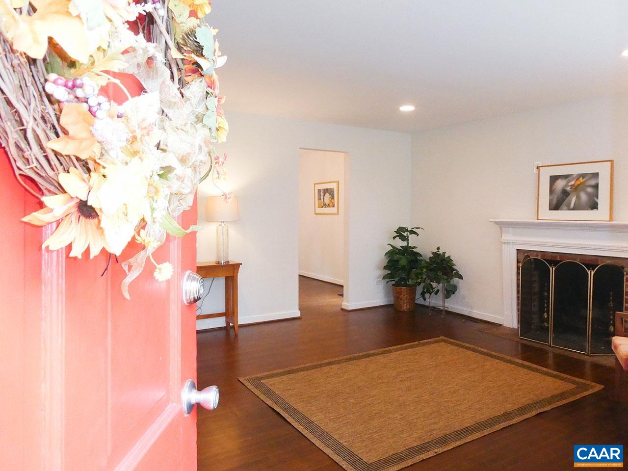 613 Shamrock Road Charlottesville, VA 22903 - Photo 2 of 42 a living room with a rug and a fireplace