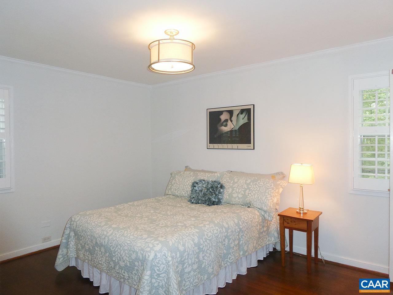 613 Shamrock Road Charlottesville, VA 22903 - Photo 22 of 42 a bedroom with a bed and a lamp