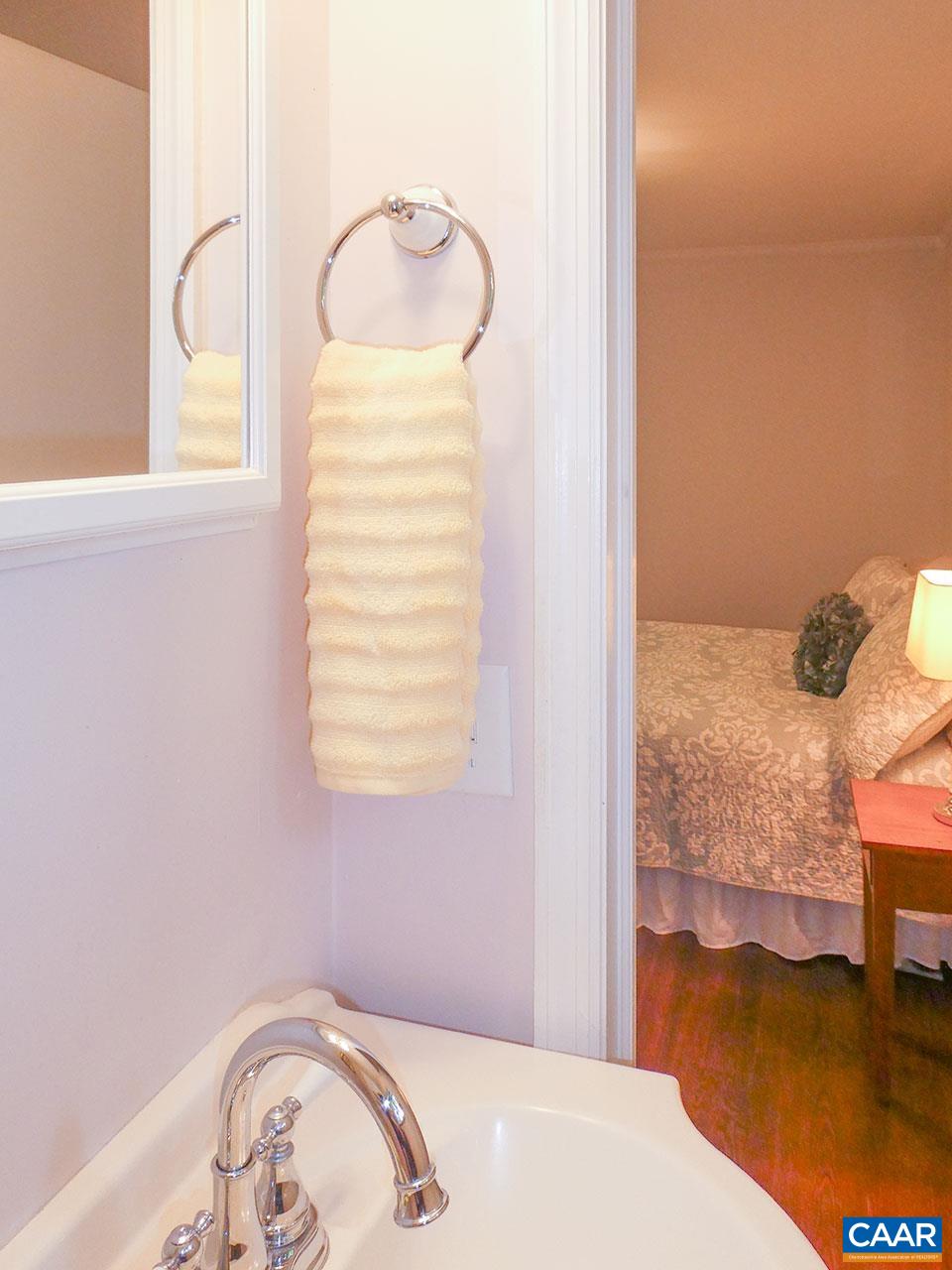 613 Shamrock Road Charlottesville, VA 22903 - Photo 26 of 42 a bedroom with a bed and a chandelier