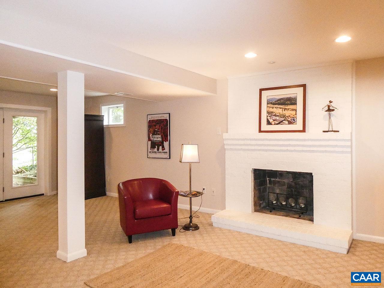 613 Shamrock Road Charlottesville, VA 22903 - Photo 30 of 42 a living room with furniture and a fireplace