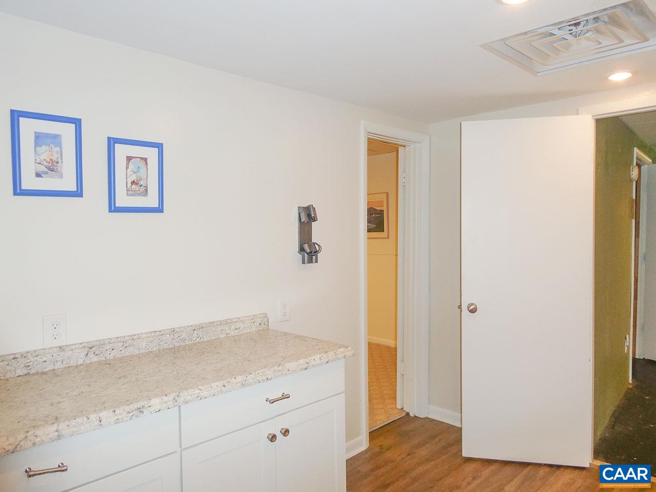 613 Shamrock Road Charlottesville, VA 22903 - Photo 39 of 42 a bathroom with a granite countertop sink and a mirror