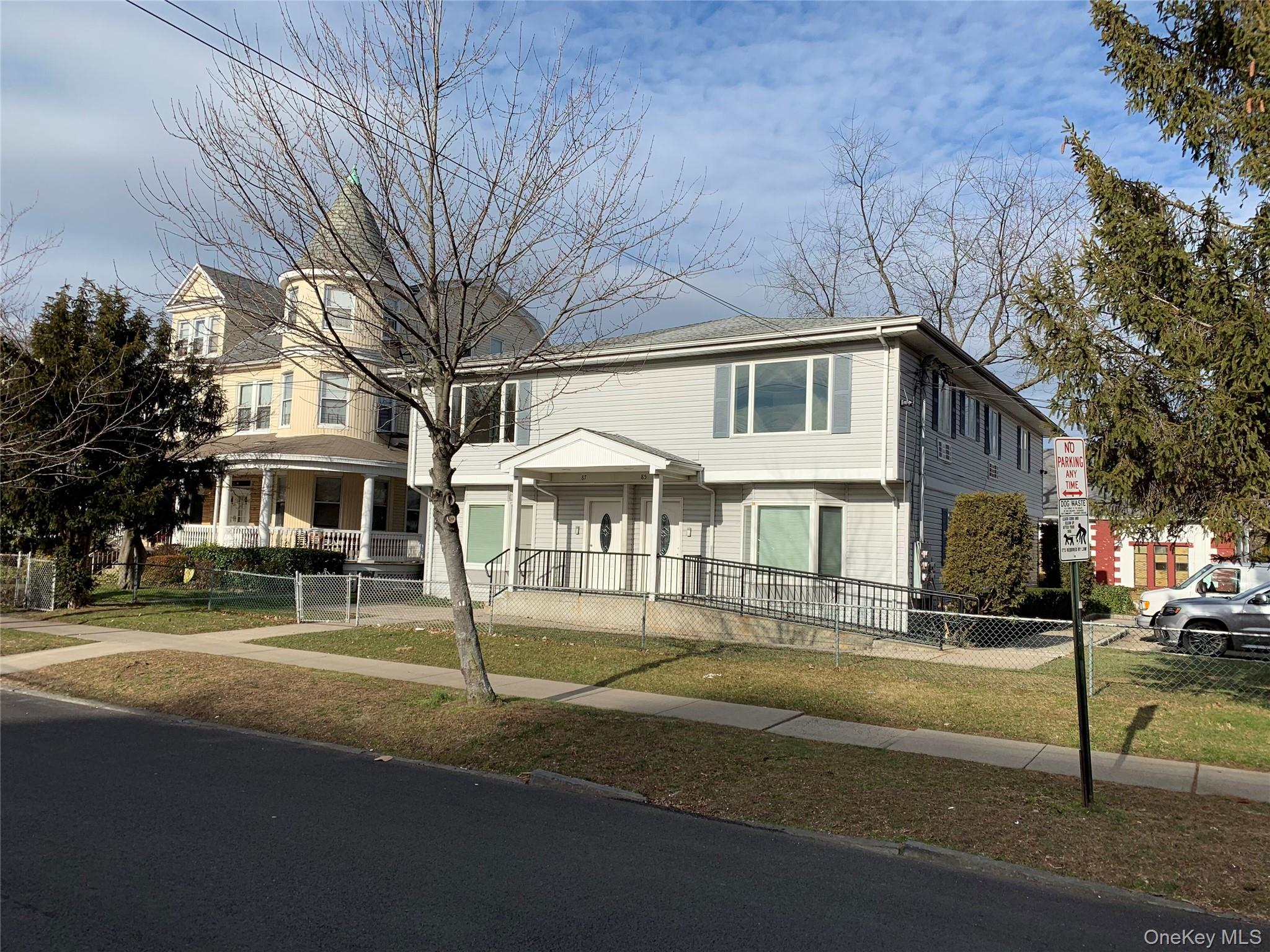 View of front of house featuring covered porch and a fenced front yard