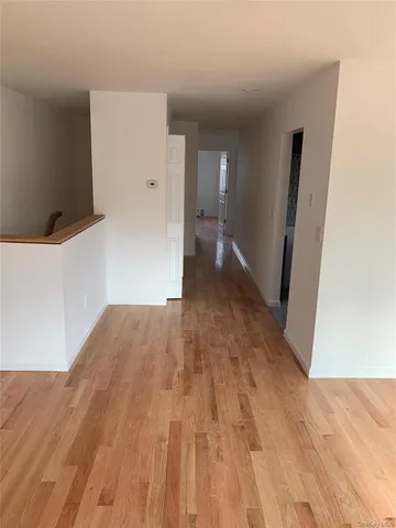 a view of hallway with wooden floor