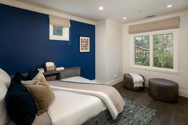 a bedroom with a bed and a glass door