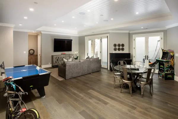 a living room with furniture a fireplace and a chandelier