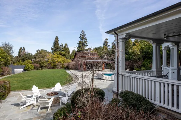 an aerial view of a house with a yard and lake view