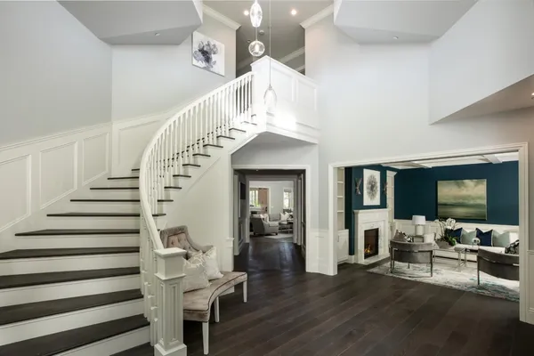 a living room with furniture a fireplace and a floor to ceiling window