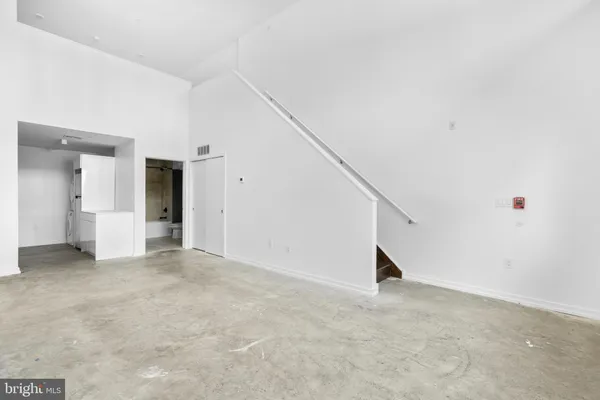 a view of empty room with white walls