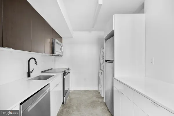 a kitchen with a sink and refrigerator