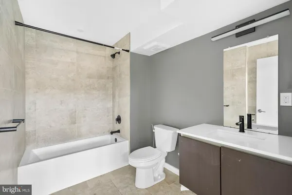 a bathroom with a toilet and a bathtub