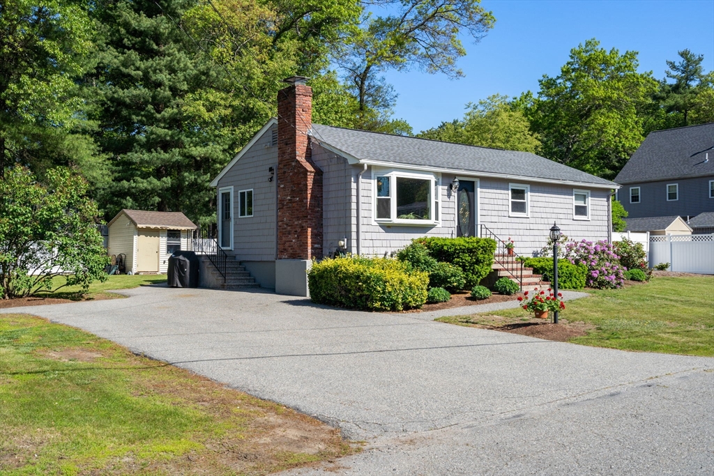 3 Norman Road Billerica, MA 01821 - Photo 3 of 28 a backyard of a house with a garden and plants