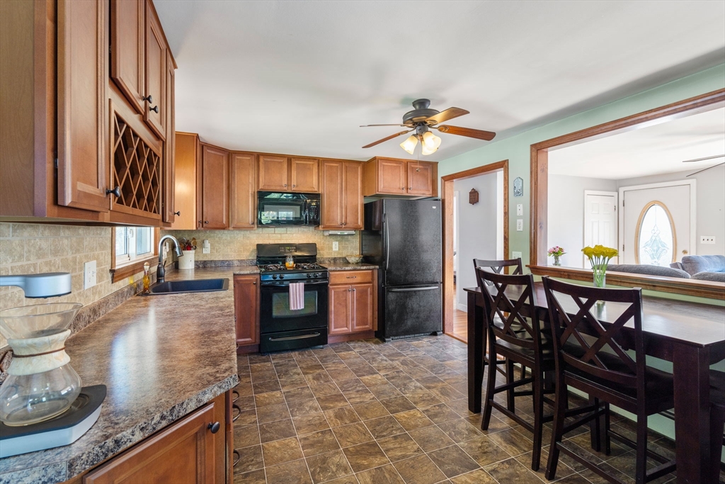 3 Norman Road Billerica, MA 01821 - Photo 5 of 28 a kitchen with stainless steel appliances granite countertop a stove a refrigerator a sink a dining table and chairs