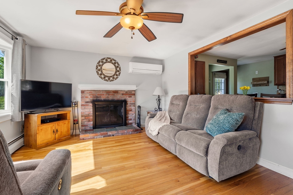 3 Norman Road Billerica, MA 01821 - Photo 8 of 28 a living room with furniture a flat screen tv and a fireplace