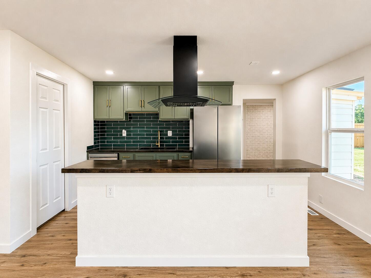 2316 48th Street Lubbock, TX 79412 - Photo 4 of 18 a kitchen with stainless steel appliances granite countertop a sink and a refrigerator