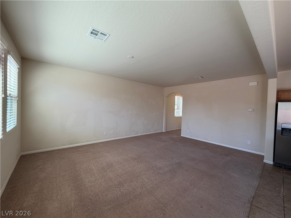 442 White Heart Road Las Vegas, NV 89148 - Photo 5 of 25 An open living space features comfortable wall-to-wall carpeting and tall windows providing natural light.