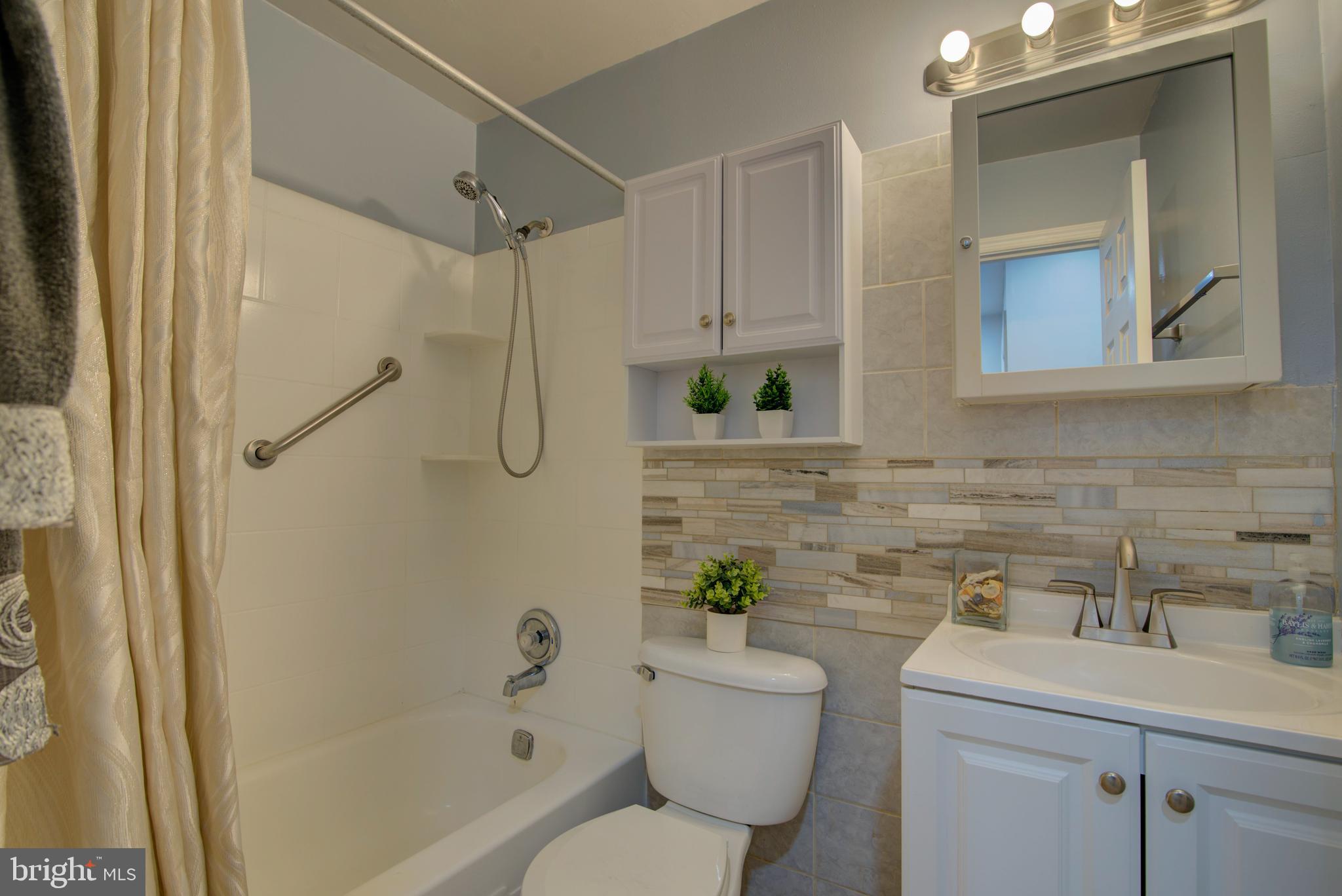 5903 Kara Place Burke, VA 22015 - Photo 26 of 45 a bathroom with a granite countertop sink a toilet and shower