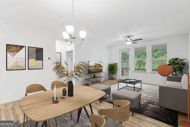 a dining room with furniture a chandelier and a large mirror