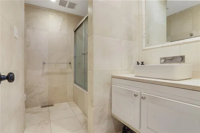 a bathroom with a shower and a sink