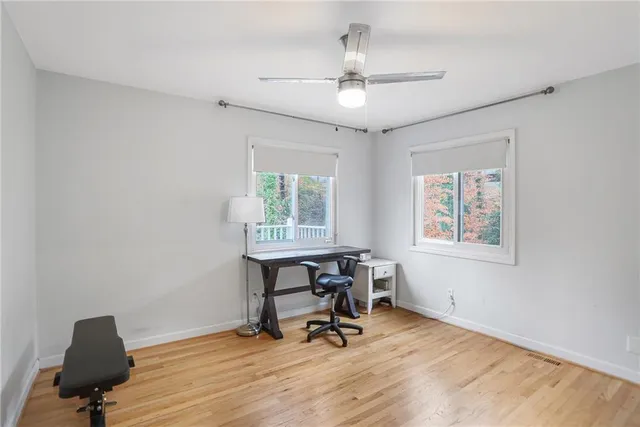 a view of a workspace with furniture and a window