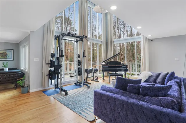a living room with furniture a rug and a window