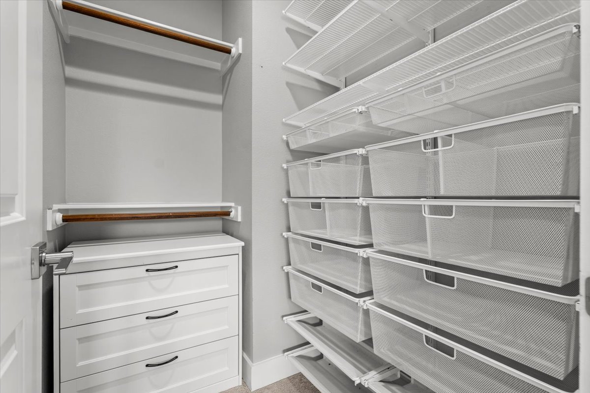 913 Stobaugh Street, Unit B Austin, TX 78757 - Photo 40 of 40 3rd Bedroom's well-appointed walk-in closet with custom shelving and integrated drawer storage for seamless organization.