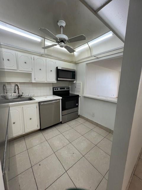 13499 Biscayne Boulevard, Unit 602 North Miami, FL 33181 - Photo 14 of 14 a kitchen with a sink a stove and cabinets