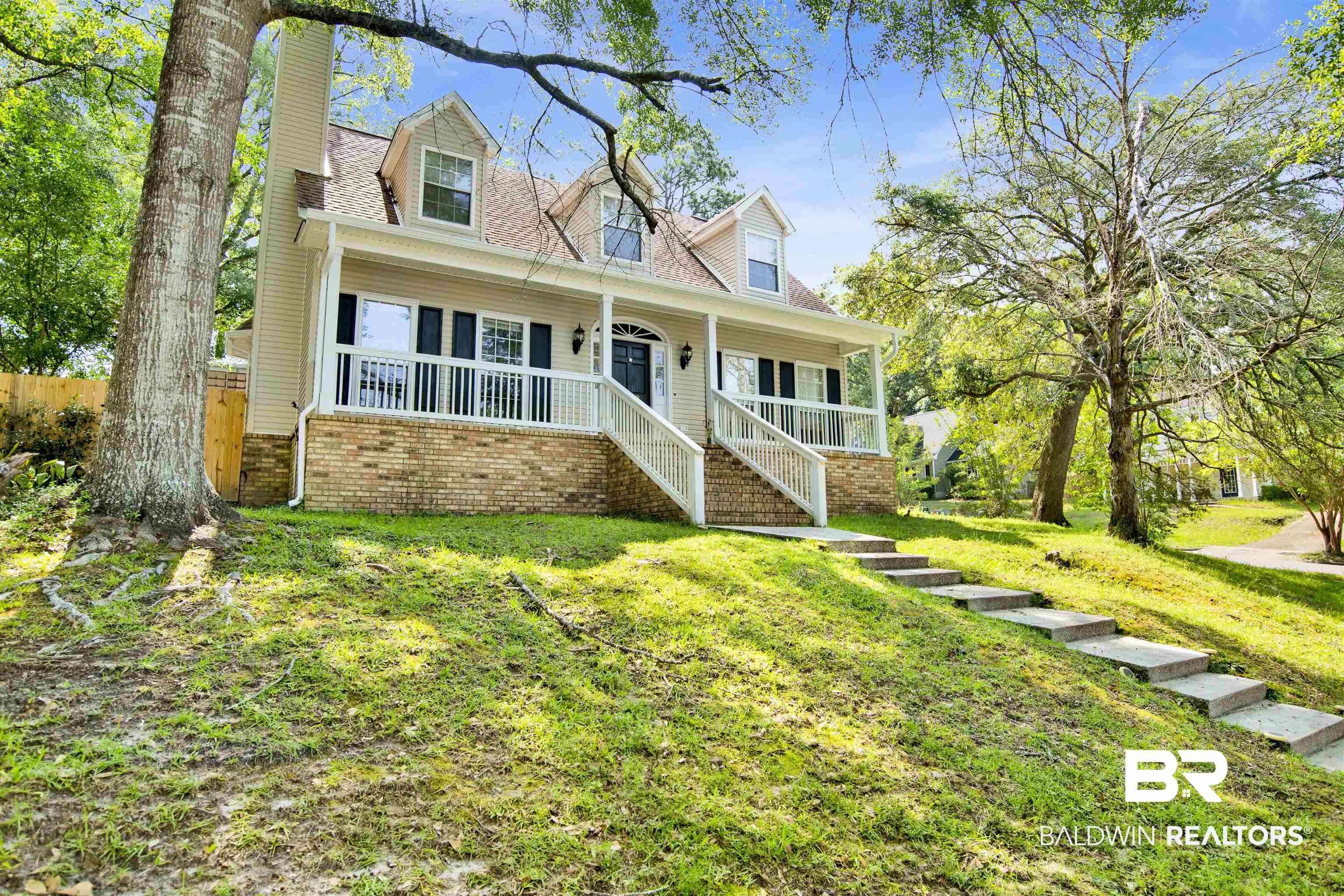 3412 Peyton Court Mobile, AL 36695 - Photo 1 of 27 New england style home with covered porch, a chimney, and stairs