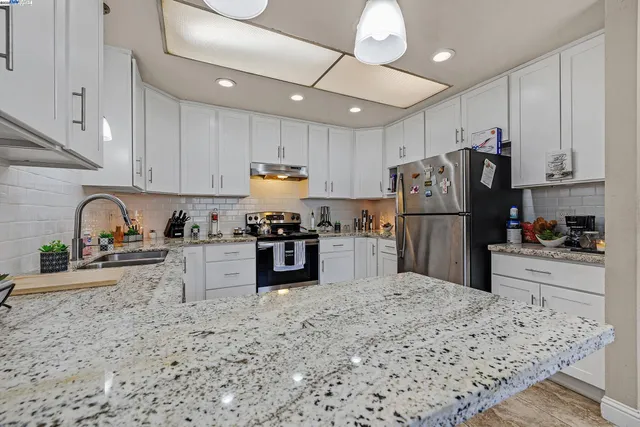 a kitchen with refrigerator and cabinets