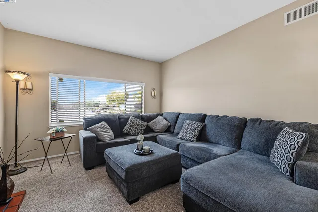 a living room with furniture and a large window