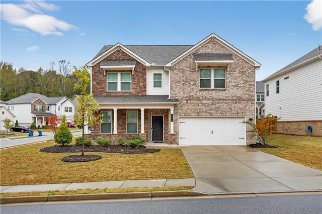 a front view of a house with a yard