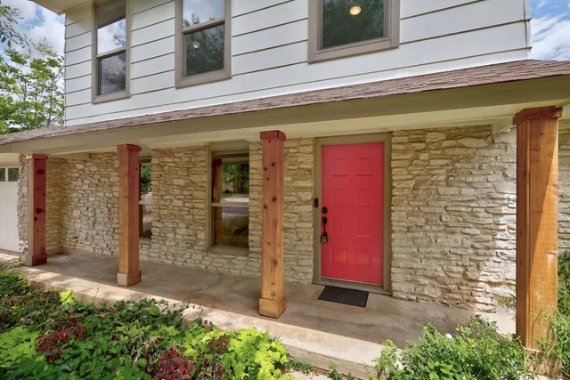 a front view of a building with a garden