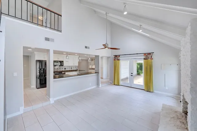 a large kitchen with stainless steel appliances kitchen island a large window and a counter top space