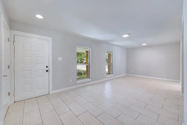 an empty room with windows and closet