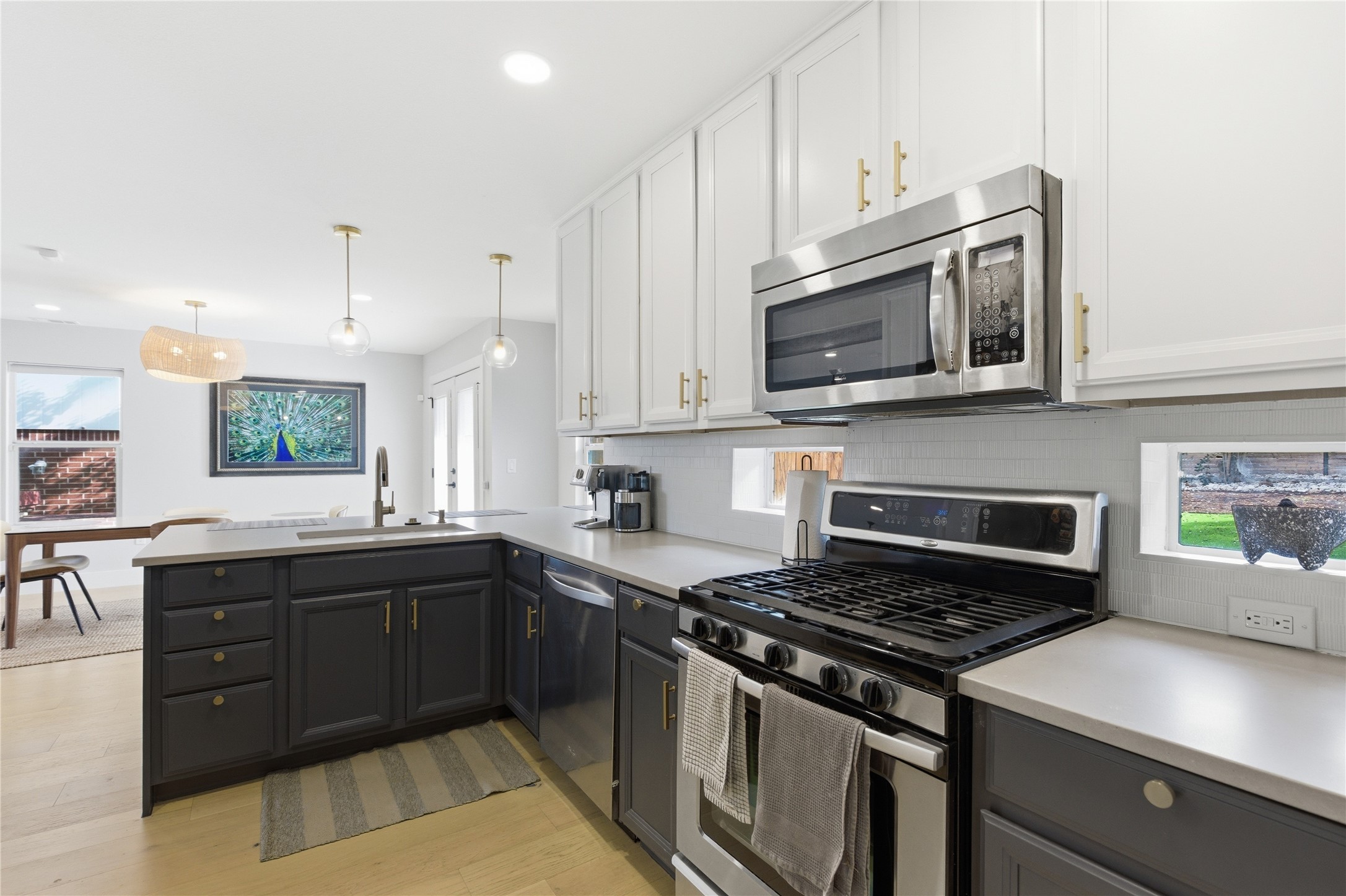 501 Lightsey Road Austin, TX 78704 - Photo 12 of 40 a kitchen with stainless steel appliances granite countertop a stove and a microwave