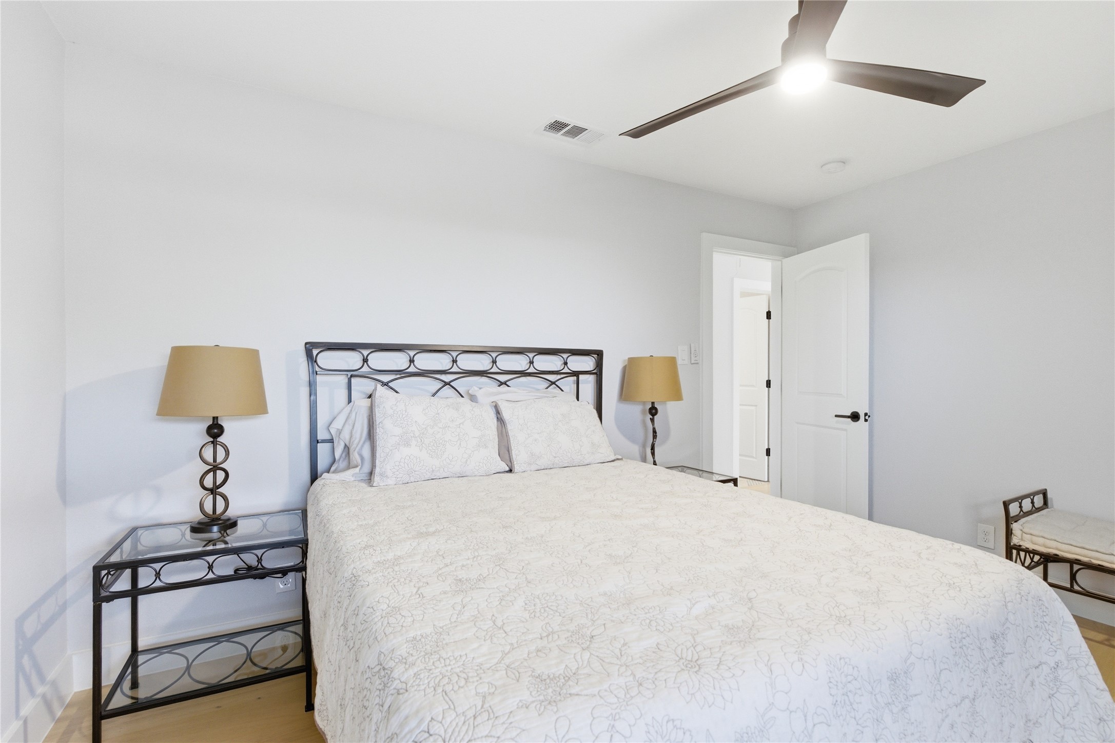 501 Lightsey Road Austin, TX 78704 - Photo 17 of 40 a bedroom with a bed and a lamp on the dresser