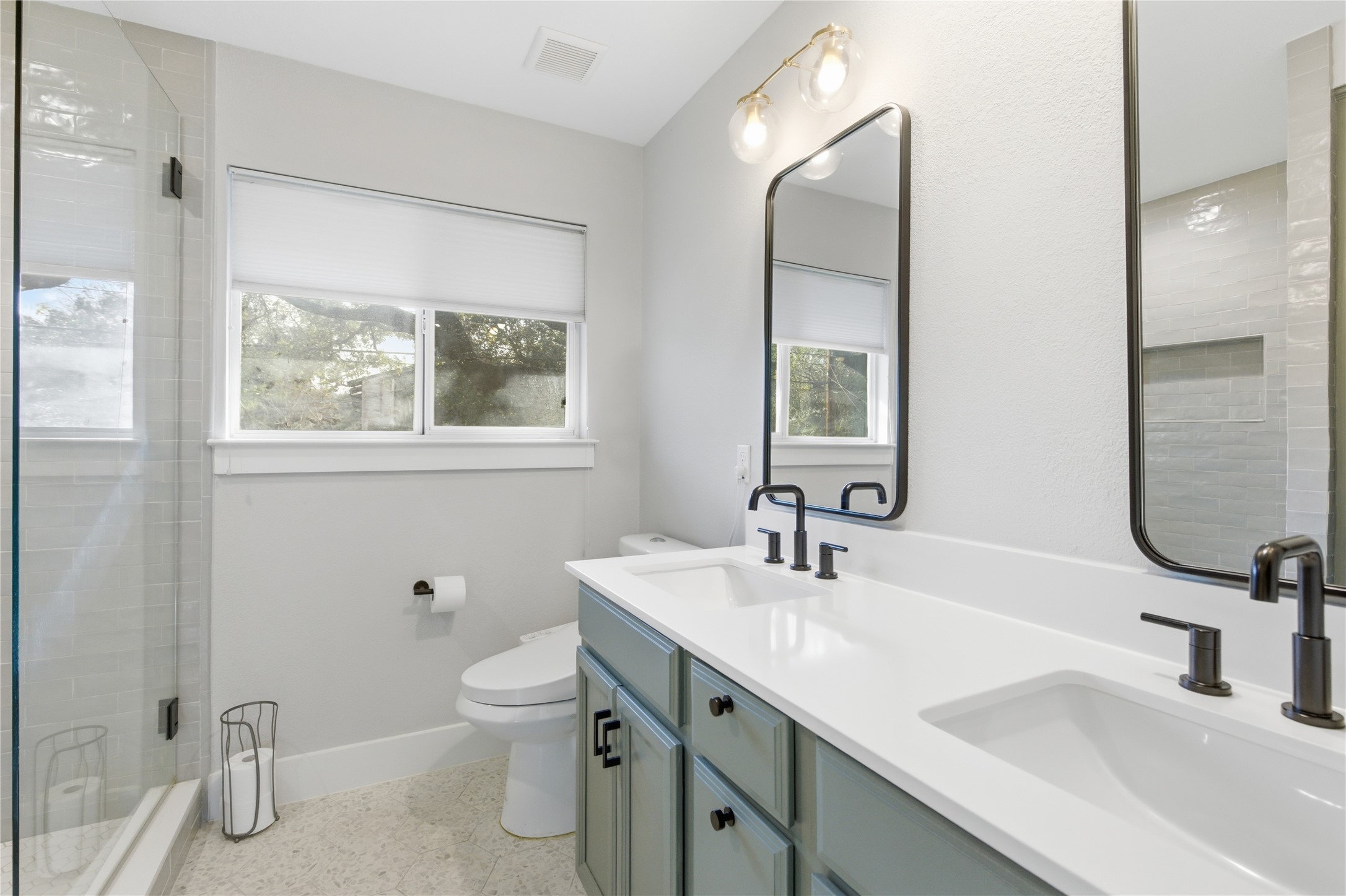501 Lightsey Road Austin, TX 78704 - Photo 21 of 40 a bathroom with a sink a toilet and a mirror