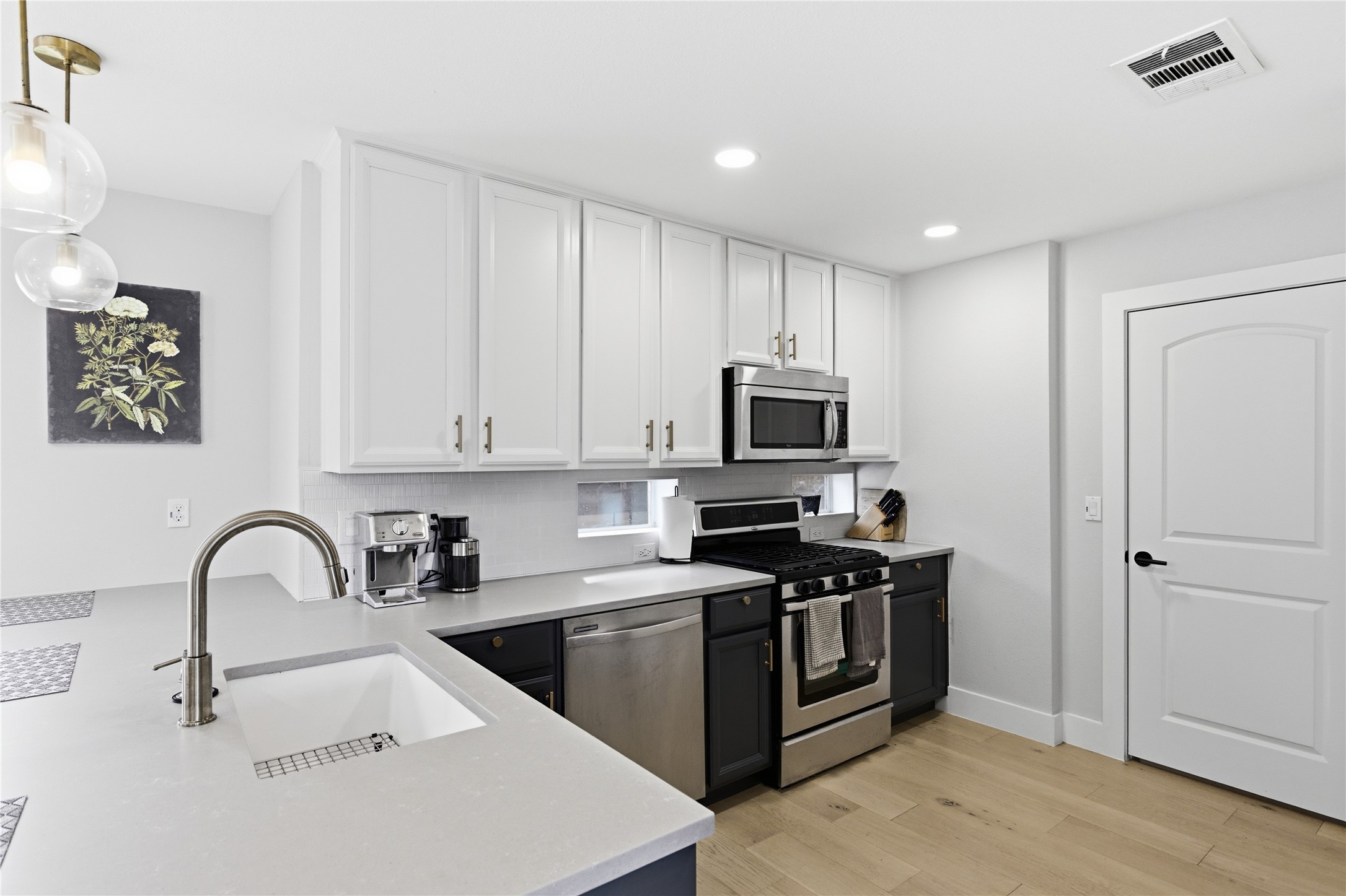 501 Lightsey Road Austin, TX 78704 - Photo 30 of 40 a kitchen with stainless steel appliances kitchen island a white stove top oven and white cabinets