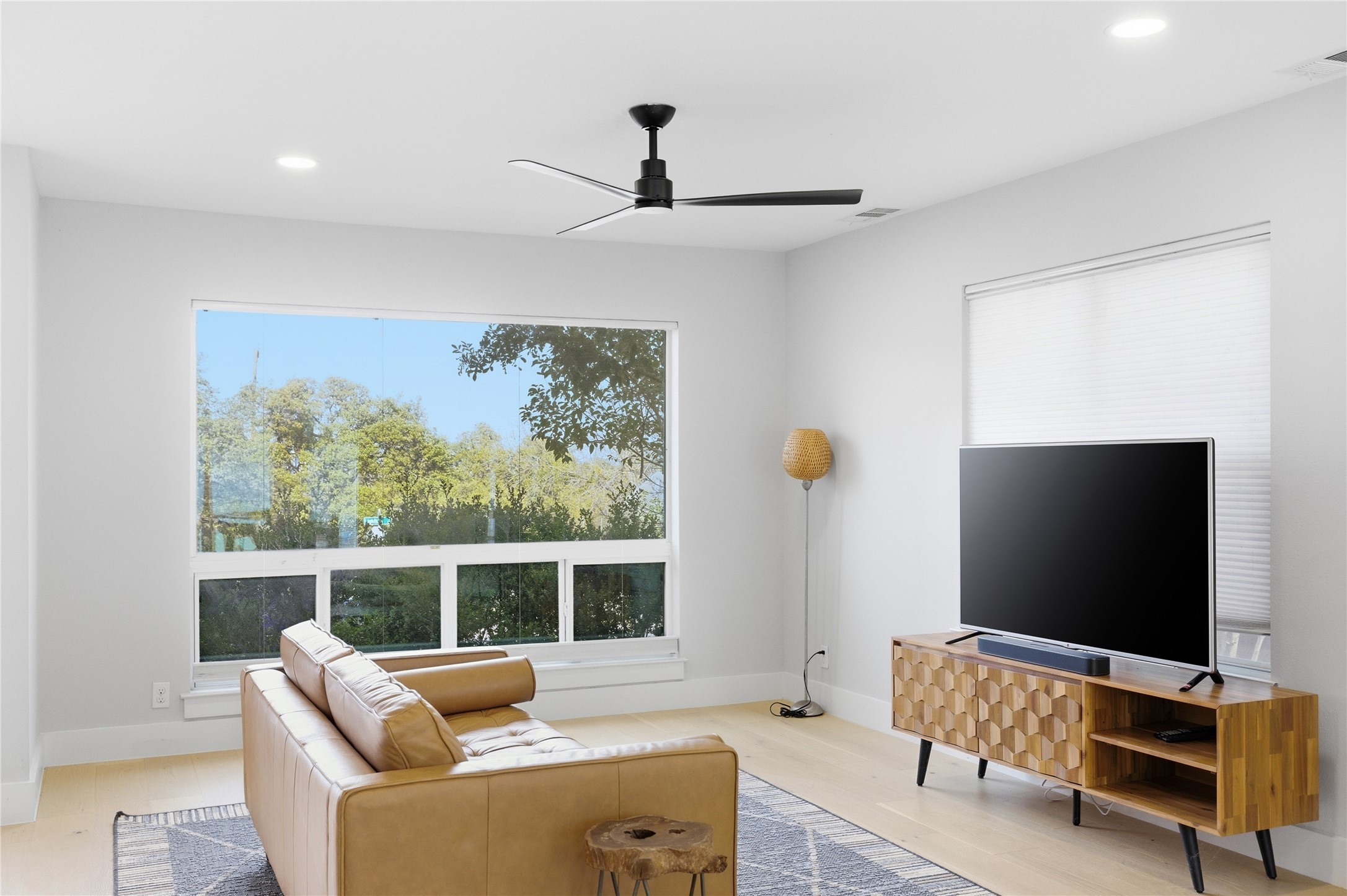501 Lightsey Road Austin, TX 78704 - Photo 33 of 40 a living room with furniture a flat screen tv and a window