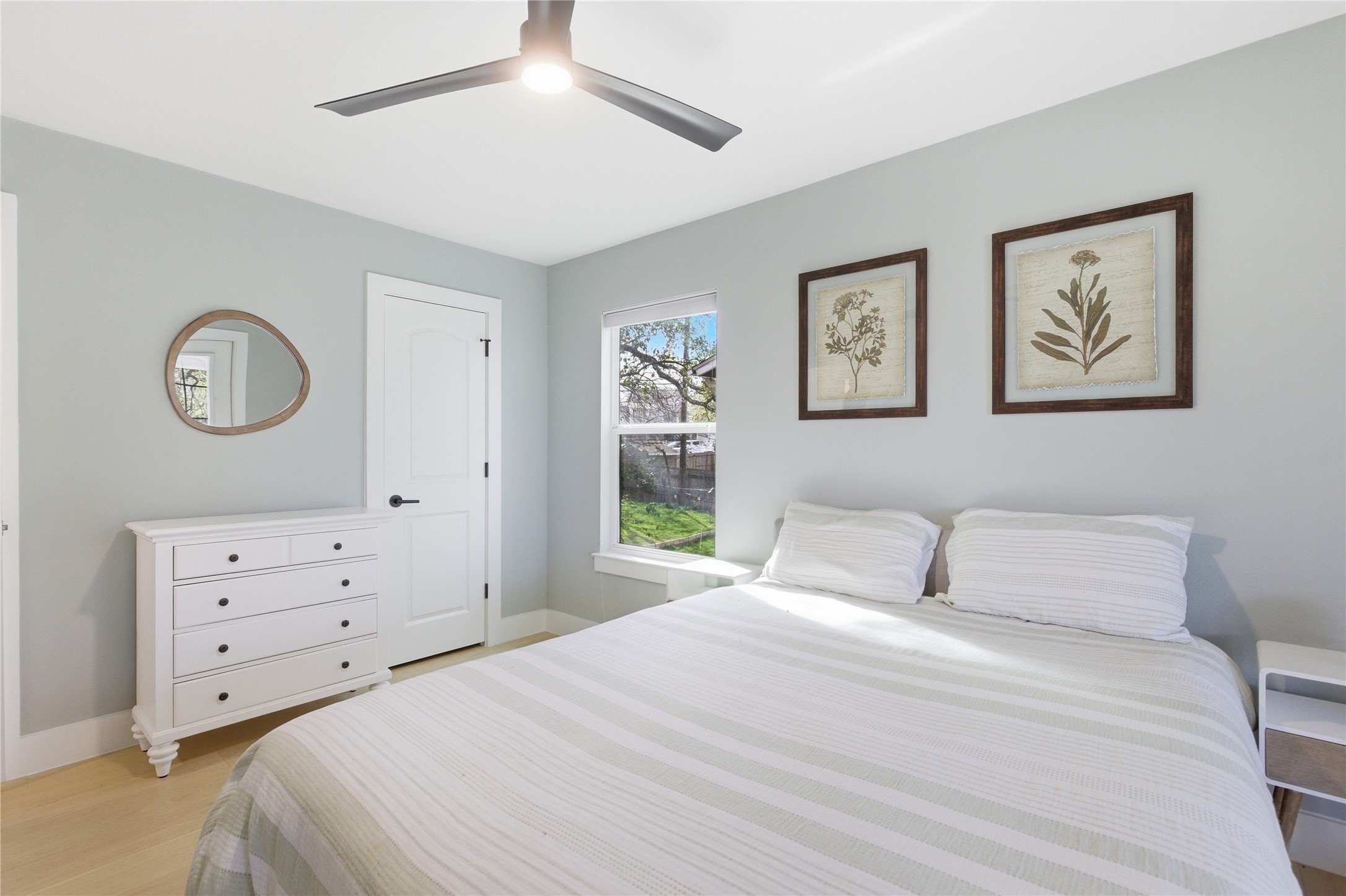 501 Lightsey Road Austin, TX 78704 - Photo 37 of 40 a bedroom with a bed and a painting on the wall